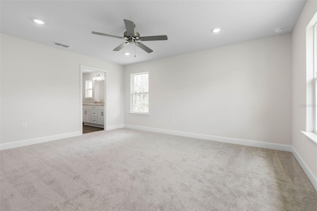 12 Squanto Pl, Palm Coast, FL 32164 - unfurnished bedroom with carpet flooring, baseboards, recessed lighting, ensuite bath, and ceiling fan