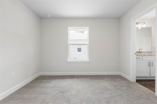 12 Squanto Pl, Palm Coast, FL 32164 - empty room featuring carpet flooring, baseboards, a sink, and a smoke detector