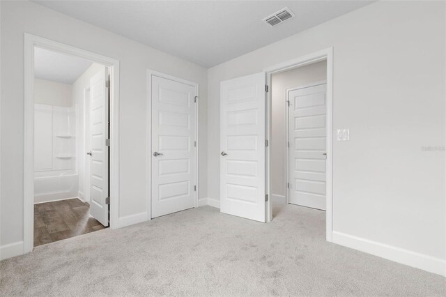 12 Squanto Pl, Palm Coast, FL 32164 - unfurnished bedroom featuring carpet, baseboards, and ensuite bath