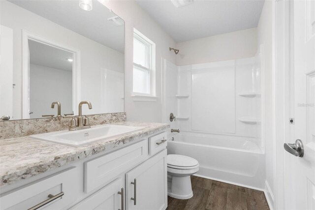 12 Squanto Pl, Palm Coast, FL 32164 - full bathroom with vanity, wood finished floors, shower / tub combination, and toilet