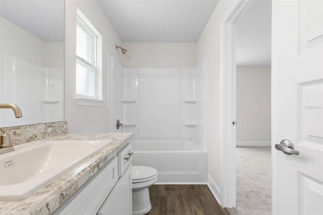 12 Squanto Pl, Palm Coast, FL 32164 - full bathroom with vanity, toilet, shower / bathtub combination, wood finished floors, and baseboards