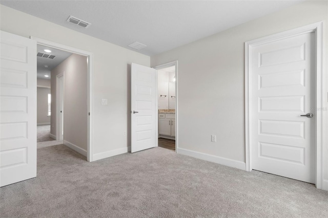 12 Squanto Pl, Palm Coast, FL 32164 - unfurnished bedroom featuring carpet floors, baseboards, and ensuite bath
