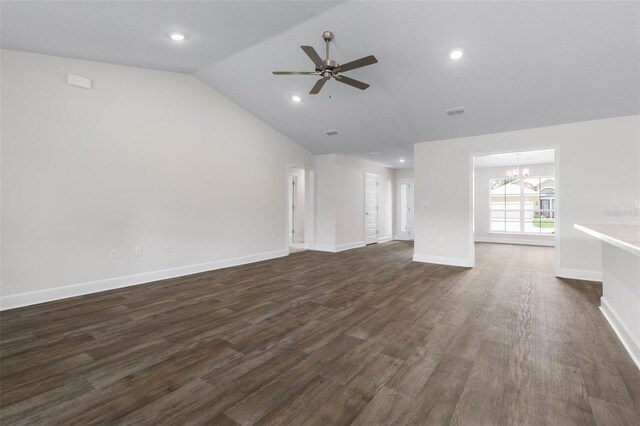 12 Squanto Pl, Palm Coast, FL 32164 - unfurnished living room featuring a chandelier, lofted ceiling, dark wood finished floors, ceiling fan, and baseboards