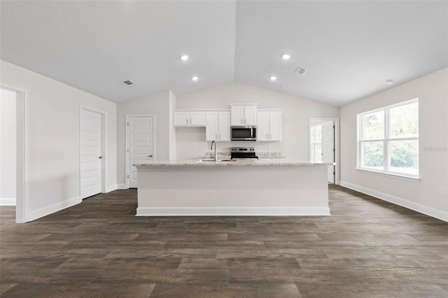 12 Squanto Pl, Palm Coast, FL 32164 - kitchen featuring stainless steel appliances, lofted ceiling, white cabinetry, a center island with sink, and a sink