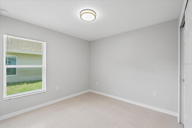 31 Secretary Trl, Palm Coast, FL 32164 - unfurnished room featuring baseboards, a textured ceiling, and light tile patterned flooring
