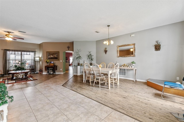 42 Buffalo Bill Dr, Palm Coast, FL 32137 - tiled dining room with visible vents, baseboards, a textured ceiling, and ceiling fan