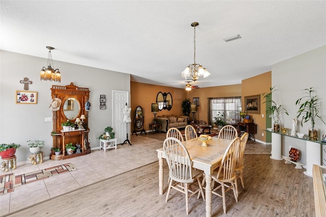42 Buffalo Bill Dr, Palm Coast, FL 32137 - dining area with visible vents, a textured ceiling, a chandelier, and light tile patterned flooring