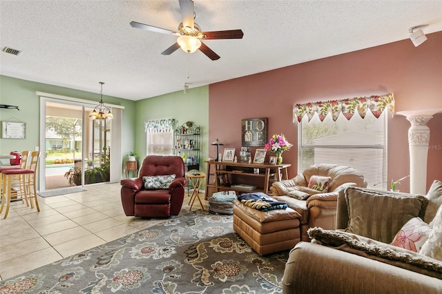 42 Buffalo Bill Dr, Palm Coast, FL 32137 - living area featuring tile patterned flooring, visible vents, ceiling fan with notable chandelier, and a textured ceiling