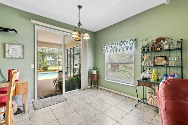 42 Buffalo Bill Dr, Palm Coast, FL 32137 - entryway with tile patterned flooring, a textured ceiling, and baseboards