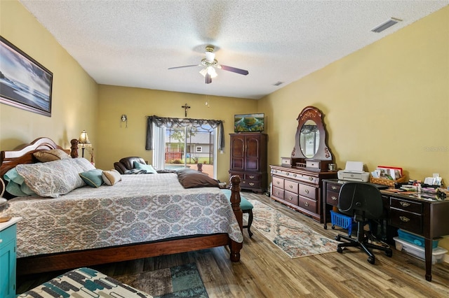 42 Buffalo Bill Dr, Palm Coast, FL 32137 - bedroom with visible vents, a textured ceiling, a ceiling fan, and wood finished floors