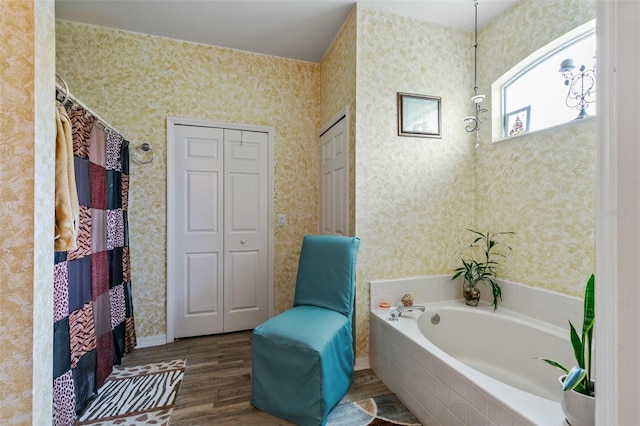 42 Buffalo Bill Dr, Palm Coast, FL 32137 - full bath with a closet, a bath, wood finished floors, and wallpapered walls