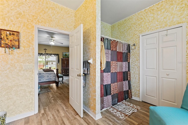 42 Buffalo Bill Dr, Palm Coast, FL 32137 - ensuite bathroom featuring baseboards, wallpapered walls, a ceiling fan, and wood finished floors