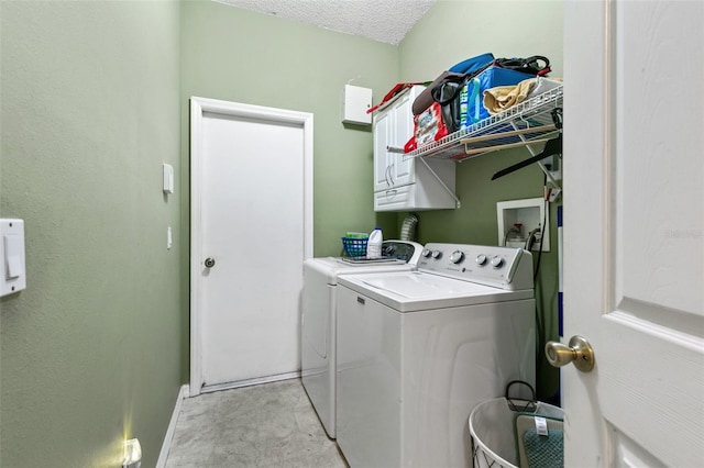 42 Buffalo Bill Dr, Palm Coast, FL 32137 - laundry room featuring cabinet space, washer and clothes dryer, baseboards, and a textured ceiling