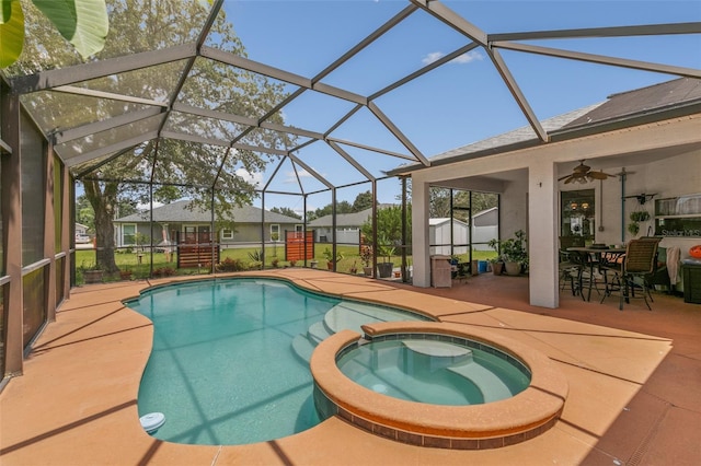 42 Buffalo Bill Dr, Palm Coast, FL 32137 - view of swimming pool featuring a patio area, a pool with connected hot tub, glass enclosure, and a ceiling fan