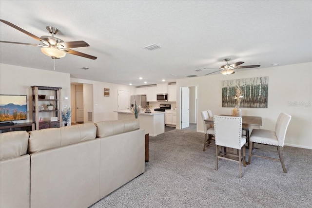 619 Grand Reserve Dr, Bunnell, FL 32110 - carpeted living room featuring visible vents, baseboards, and a ceiling fan