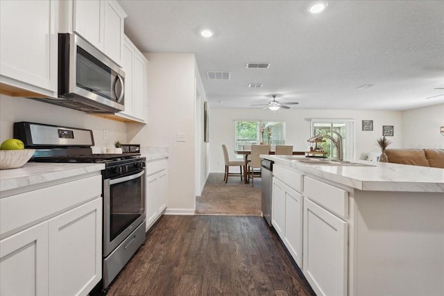 619 Grand Reserve Dr, Bunnell, FL 32110 - kitchen with a sink, a ceiling fan, visible vents, and stainless steel appliances
