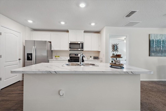 619 Grand Reserve Dr, Bunnell, FL 32110 - kitchen with stainless steel appliances, visible vents, white cabinetry, and a sink