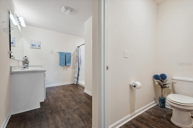 619 Grand Reserve Dr, Bunnell, FL 32110 - full bath with toilet, vanity, wood finished floors, and baseboards