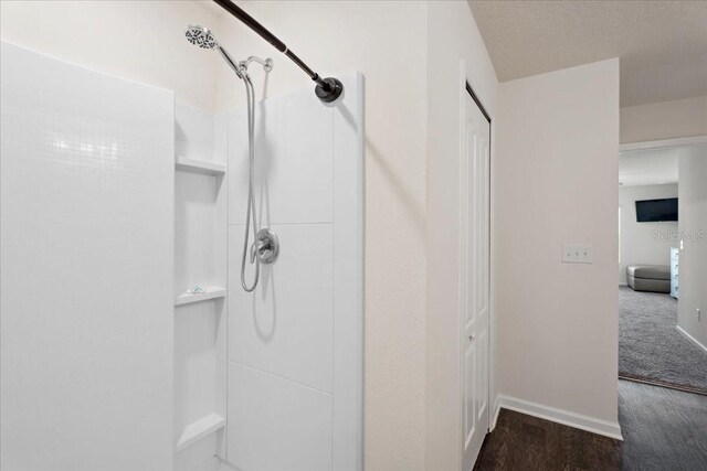 619 Grand Reserve Dr, Bunnell, FL 32110 - full bathroom with baseboards, walk in shower, and wood finished floors