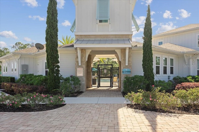 619 Grand Reserve Dr, Bunnell, FL 32110 - property entrance with board and batten siding and a gate