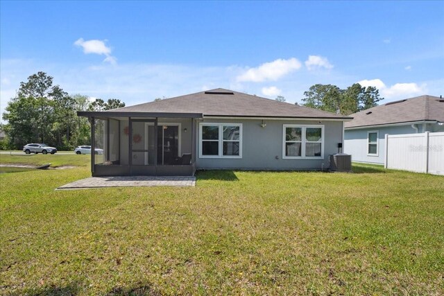 619 Grand Reserve Dr, Bunnell, FL 32110 - back of house with fence, cooling unit, a sunroom, and a lawn