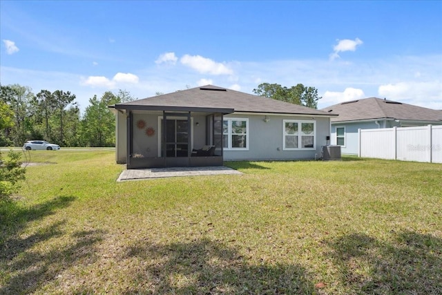 619 Grand Reserve Dr, Bunnell, FL 32110 - rear view of house featuring fence, cooling unit, a sunroom, and a lawn