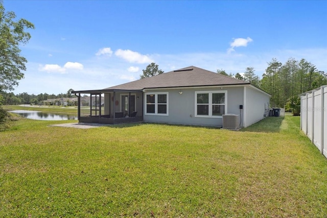 619 Grand Reserve Dr, Bunnell, FL 32110 - rear view of property featuring a water view, a yard, central AC unit, and a sunroom