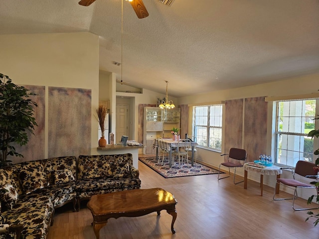8 Rickenbacker Dr, Palm Coast, FL 32164 - living area featuring a textured ceiling, a wealth of natural light, and lofted ceiling