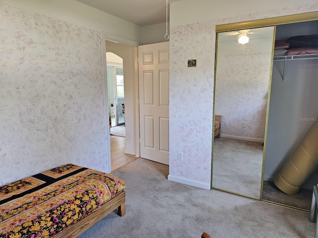 8 Rickenbacker Dr, Palm Coast, FL 32164 - bedroom featuring arched walkways, carpet floors, and a closet