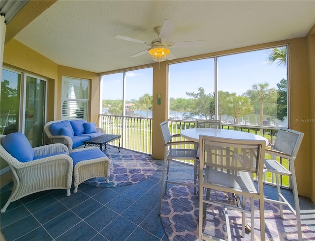 sunroom with ceiling fan and an outdoor hangout area