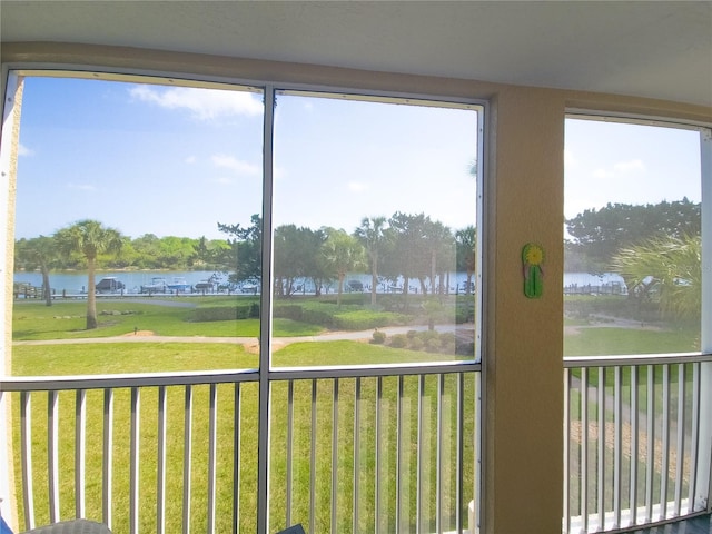 unfurnished sunroom featuring a water view