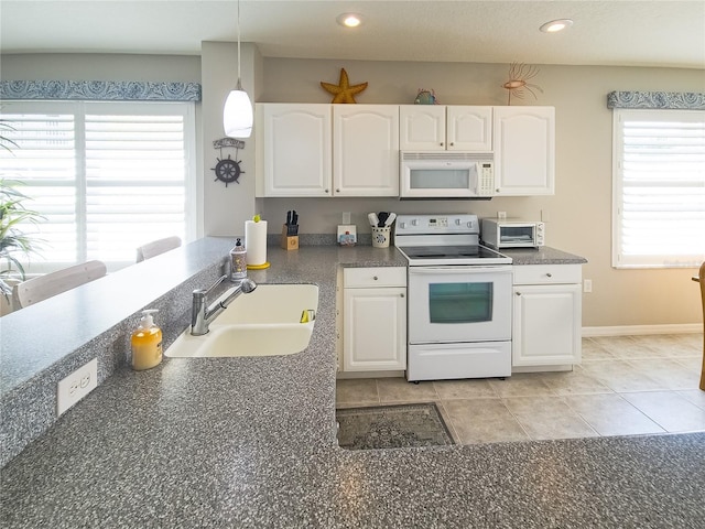 kitchen with a sink, white cabinetry, and white appliances