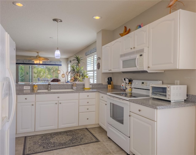 kitchen featuring white cabinets, decorative light fixtures, a sink, white appliances, and light tile patterned flooring