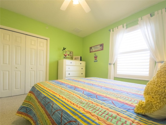 carpeted bedroom with a closet and a ceiling fan