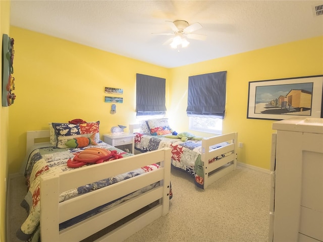 bedroom featuring visible vents, baseboards, and a ceiling fan