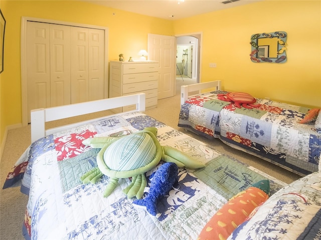 bedroom with a closet, carpet, and visible vents