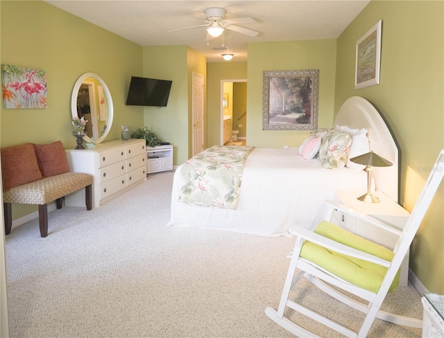 bedroom with ensuite bathroom, ceiling fan, and carpet flooring