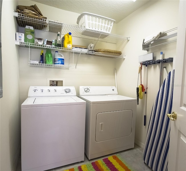 clothes washing area featuring independent washer and dryer and laundry area