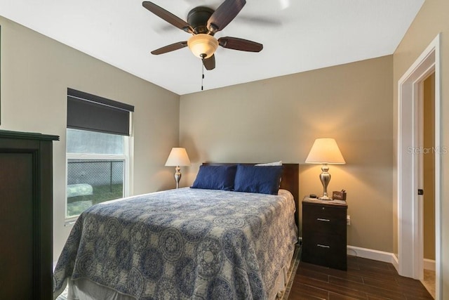 bedroom with baseboards, a ceiling fan, and wood finished floors