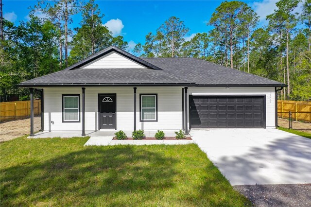 10625 Amos Ave, Hastings, FL 32145 - view of front of house featuring a front yard, a shingled roof, a garage, fence, and driveway
