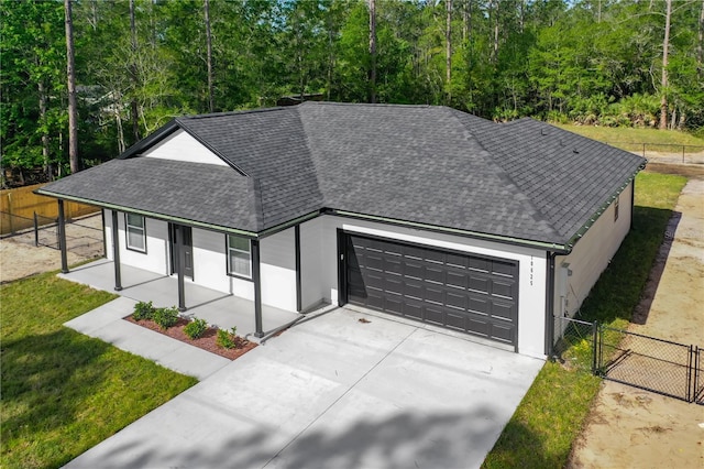 10625 Amos Ave, Hastings, FL 32145 - view of front of house featuring concrete driveway, roof with shingles, a porch, a garage, and fence