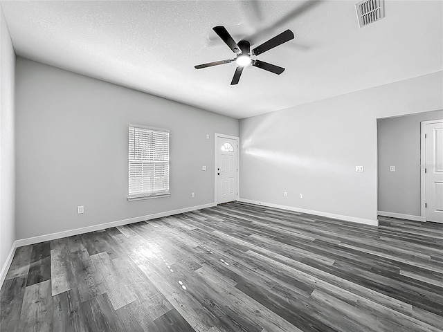 10625 Amos Ave, Hastings, FL 32145 - unfurnished living room with visible vents, a textured ceiling, a ceiling fan, and dark wood-style floors