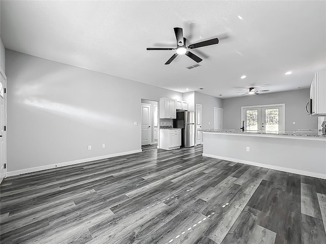 10625 Amos Ave, Hastings, FL 32145 - unfurnished living room with dark wood-type flooring, visible vents, baseboards, and a ceiling fan