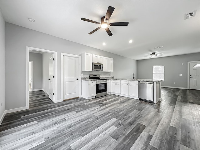 10625 Amos Ave, Hastings, FL 32145 - kitchen with open floor plan, visible vents, ceiling fan, and appliances with stainless steel finishes