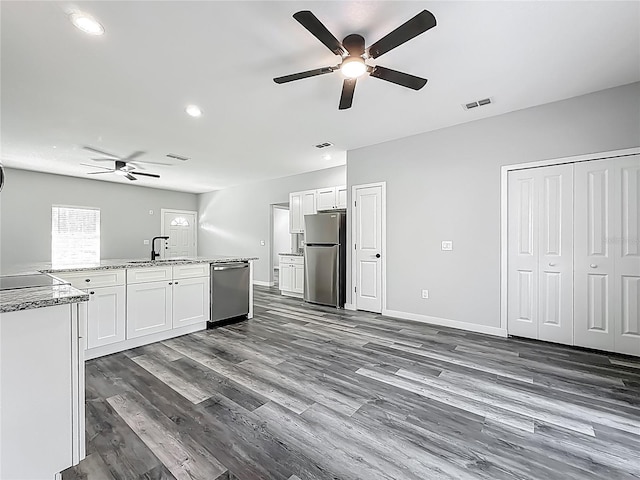 10625 Amos Ave, Hastings, FL 32145 - kitchen with visible vents, a sink, ceiling fan, white cabinetry, and stainless steel appliances
