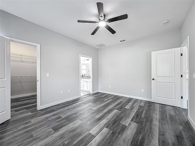 10625 Amos Ave, Hastings, FL 32145 - unfurnished bedroom with a spacious closet, visible vents, baseboards, and dark wood-style floors