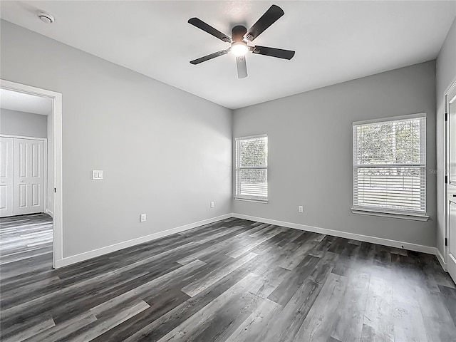 10625 Amos Ave, Hastings, FL 32145 - unfurnished room featuring dark wood-style flooring, baseboards, and a ceiling fan
