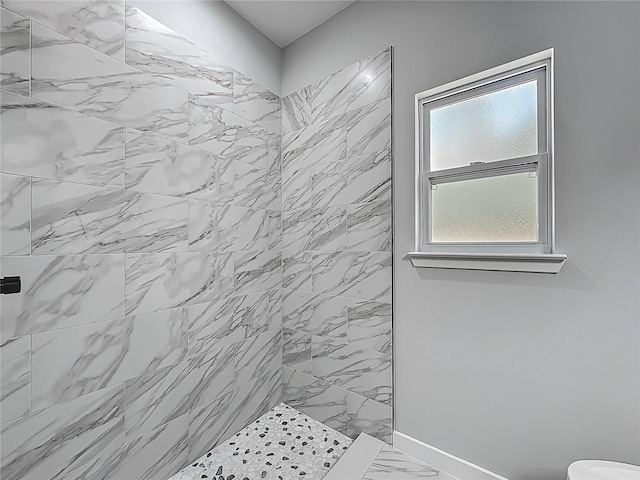 10625 Amos Ave, Hastings, FL 32145 - bathroom featuring tiled shower, marble finish floor, baseboards, and toilet