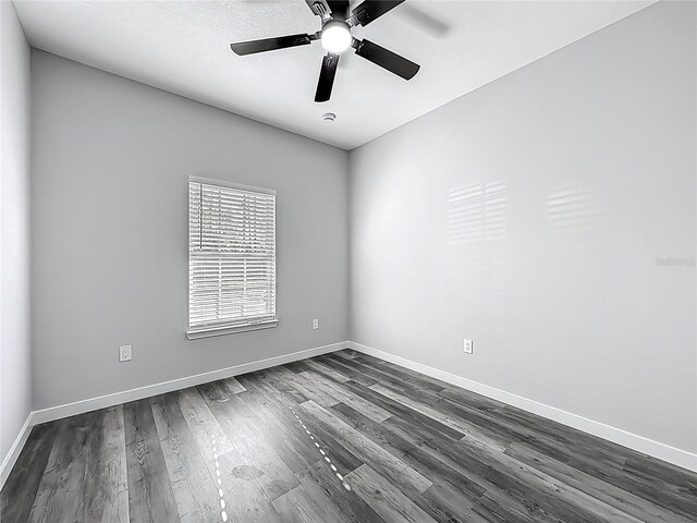 10625 Amos Ave, Hastings, FL 32145 - empty room with dark wood-type flooring, baseboards, and ceiling fan