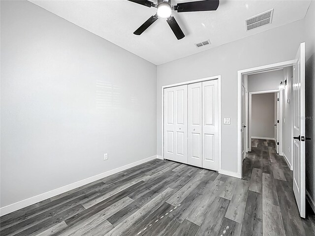 10625 Amos Ave, Hastings, FL 32145 - unfurnished bedroom with dark wood-style flooring, visible vents, baseboards, and a closet